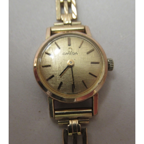 217 - A lady's Omega gold plated, stainless steel cased Omega wristwatch, on a 9ct gold gate link strap wi... 