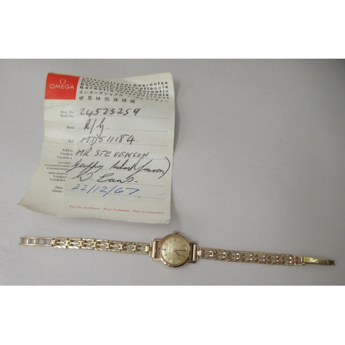 217 - A lady's Omega gold plated, stainless steel cased Omega wristwatch, on a 9ct gold gate link strap wi... 