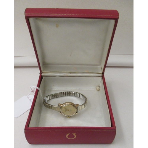 238 - A lady's Omega 9ct gold cased automatic wristwatch, faced by a baton dial, with an Omega box