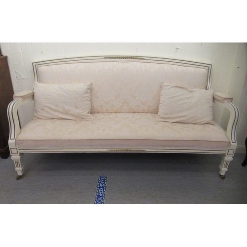 239 - A late 19thC style Continental cream painted and gilded showwood framed settee with a low arch back ... 