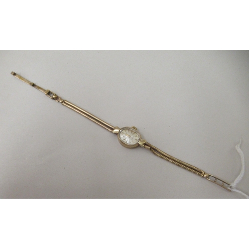 265 - A Rotary 9ct gold cased and strapped wristwatch, faced by a baton dial