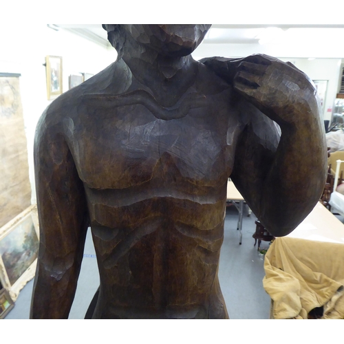 281 - A carved and stained wood statue, a standing male nude  36