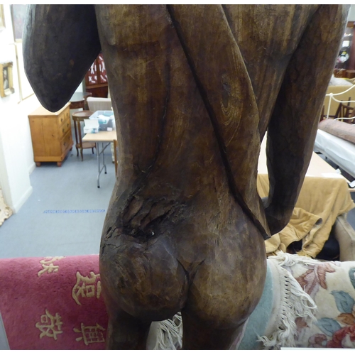 281 - A carved and stained wood statue, a standing male nude  36