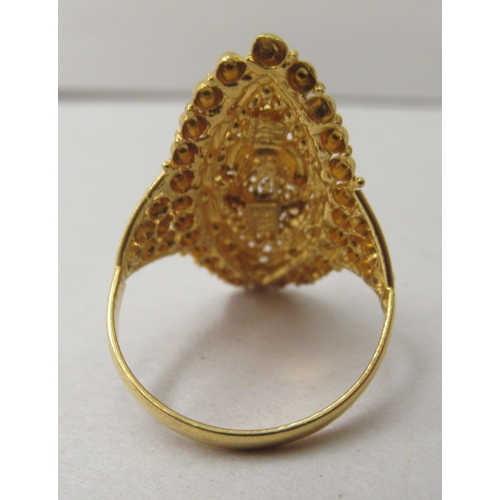 296 - A yellow Asian inspired metal ring, decorated with wire and beadwork  stamped 21K