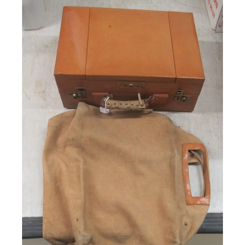 31 - An inter-war period vanity case, in a tan coloured stitched hide with a part fitted interior; and en... 