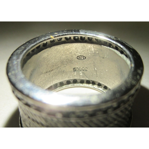 310 - A silver wide band design ring, set with two parallel rows of white stones