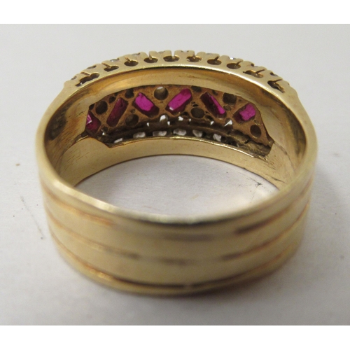 316 - An 18ct gold ring, set with zig-zag rubies within a diamond surround