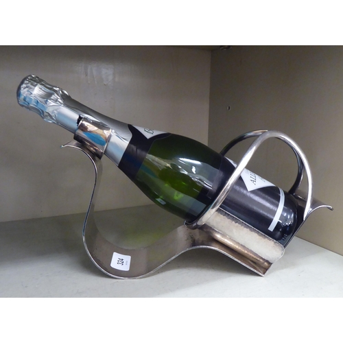 324 - A spot hammered EPNS wine bottle cradle