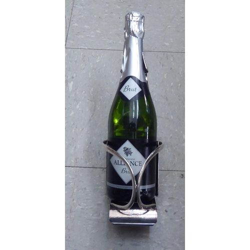 324 - A spot hammered EPNS wine bottle cradle