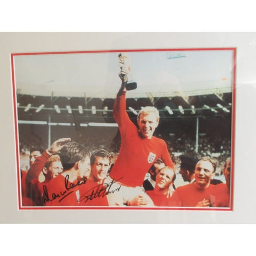 33 - A photographic print celebrating England's 4-2 1966 World Cup victory, bearing the signatures of Sir... 