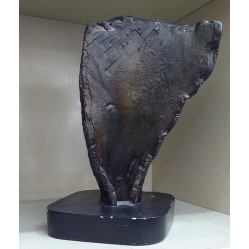 331 - A modern bronze study of a face, on a black plaster base  bears the signature Hazel  12