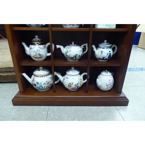 337 - A set of twelve porcelain teapots from the Victorian and Albert Museum Historic Teapot Collection, i... 