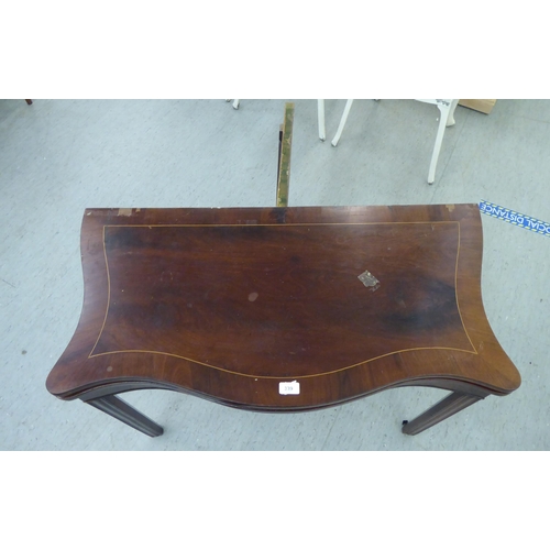 339 - A Regency mahogany serpentine front, foldover card table, raised on chamfered square legs  29