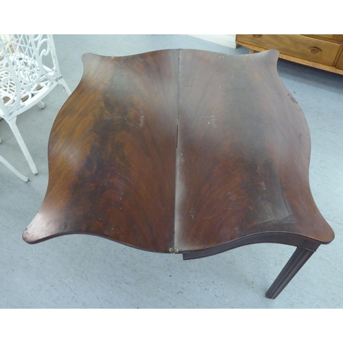 339 - A Regency mahogany serpentine front, foldover card table, raised on chamfered square legs  29