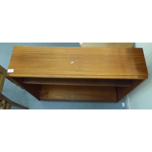 346 - A modern teak open front, two tier bookcase, on a plinth  34