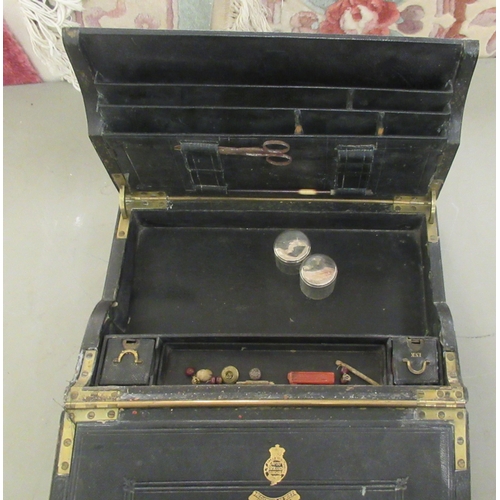 354 - A 19thC black hide clad writing box with a recessed, folding brass handle, the lockable lid with a f... 