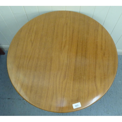 365 - A 1970s laminated teak effect coffee table, raised on splayed tubular metal legs  22