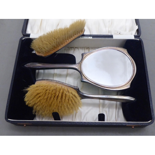 373 - A three piece silver and green enamel backed dressing table set  Birmingham 1936  cased