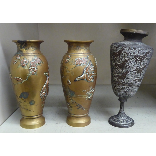 375 - 20thC Asian metalware: to include a pair of Japanese bronze vases, decorated in relief with birds an... 