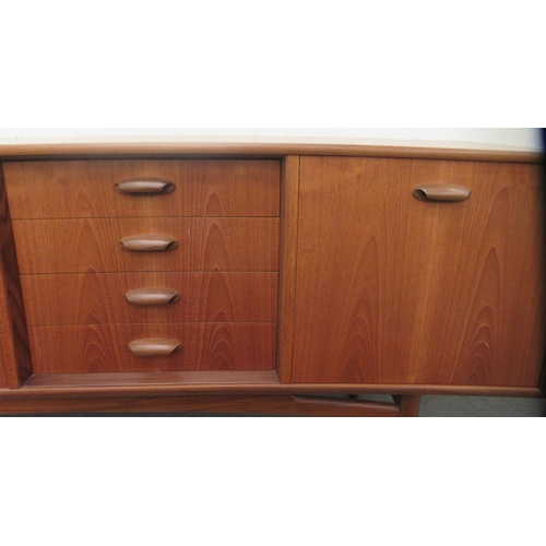 38 - A G-Plan teak sideboard, comprising a pair of cupboard doors, an adjacent bank of four drawers and a... 