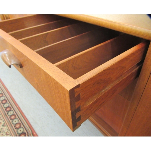 38 - A G-Plan teak sideboard, comprising a pair of cupboard doors, an adjacent bank of four drawers and a... 