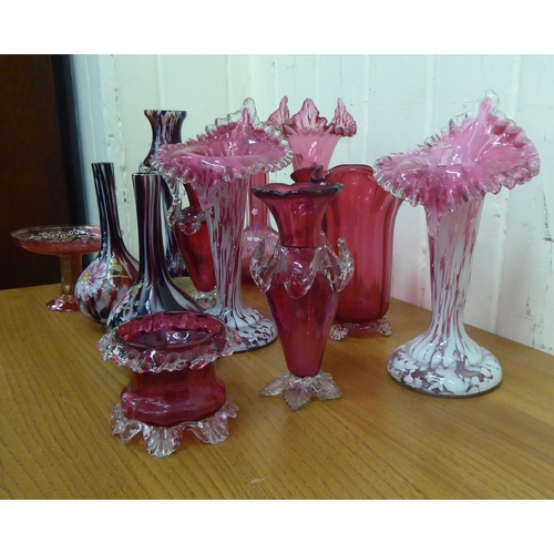 4 - Cranberry and similarly coloured glass of varying designs: to include a pair of bottle vases, decora... 