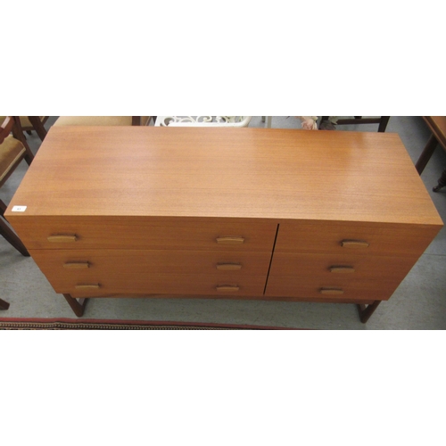 43 - A G-Plan teak bedroom chest, comprising three long drawers and three adjacent shorter drawers, raise... 