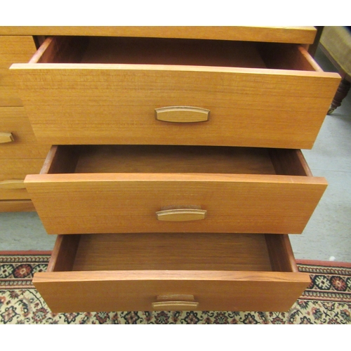 43 - A G-Plan teak bedroom chest, comprising three long drawers and three adjacent shorter drawers, raise... 