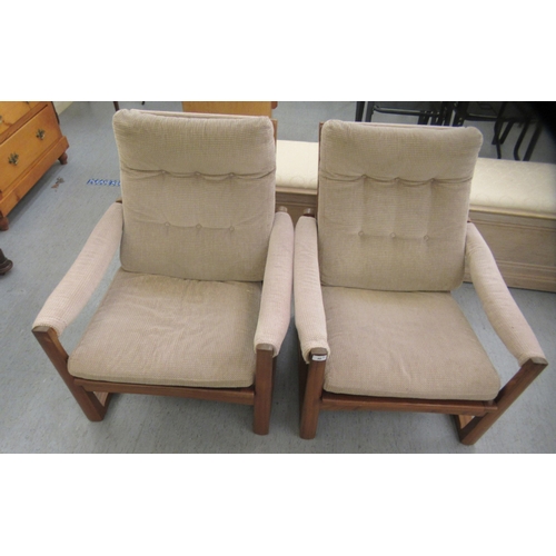 46 - A pair of 1960s/1970s Guy Rogers teak framed and cushion upholstered, open arm easy chairs 