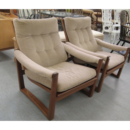 46 - A pair of 1960s/1970s Guy Rogers teak framed and cushion upholstered, open arm easy chairs 