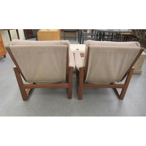 46 - A pair of 1960s/1970s Guy Rogers teak framed and cushion upholstered, open arm easy chairs 