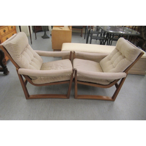 46 - A pair of 1960s/1970s Guy Rogers teak framed and cushion upholstered, open arm easy chairs 