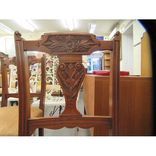 49 - A late Victorian set of six carved mahogany framed boudoir chairs, each with a bar crest and vase sh... 