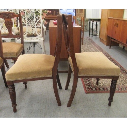 49 - A late Victorian set of six carved mahogany framed boudoir chairs, each with a bar crest and vase sh... 