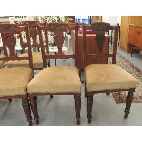 49 - A late Victorian set of six carved mahogany framed boudoir chairs, each with a bar crest and vase sh... 