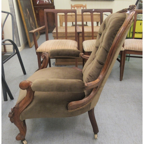 50 - A late Victorian floral and scroll carved walnut showwood framed spoonback chair with open arms, par... 