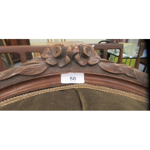 50 - A late Victorian floral and scroll carved walnut showwood framed spoonback chair with open arms, par... 