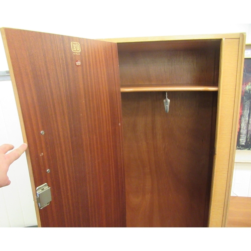 56 - A G-Plan light oak moulded wardrobe, enclosed by a full height doors  69