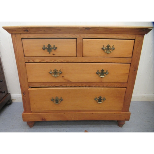 61 - A waxed pine dressing chest, comprising two short/two long drawers with brass handles, raised on tur... 