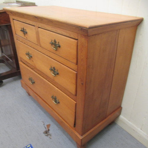 61 - A waxed pine dressing chest, comprising two short/two long drawers with brass handles, raised on tur... 