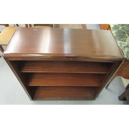 66 - A 20thC mahogany open front two tier bookcase, on a plinth  40