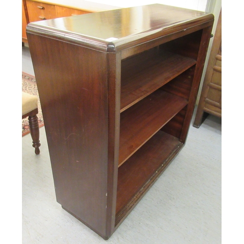 66 - A 20thC mahogany open front two tier bookcase, on a plinth  40