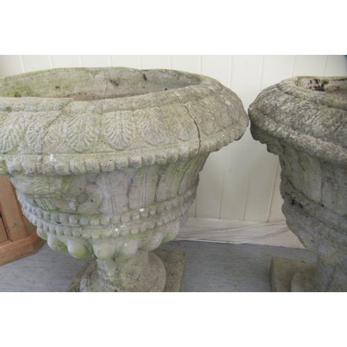 68 - A pair of composition stone pedestal planters, on square plinths  24