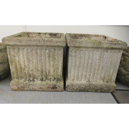 70 - A pair of composition stone planters of box design with fluted ornament  18