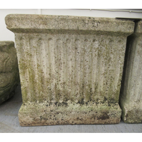 70 - A pair of composition stone planters of box design with fluted ornament  18