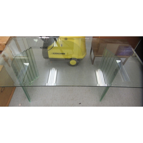 86 - A modern tinted green glass dining table, raised on concave pedestals  30