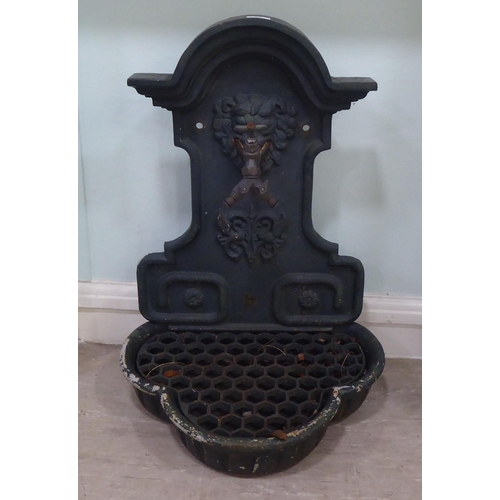 96 - A Georgian inspired cast iron backplate with a two direction front facing tap, over a grill and rese... 