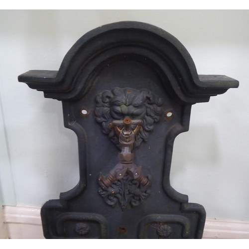 96 - A Georgian inspired cast iron backplate with a two direction front facing tap, over a grill and rese... 