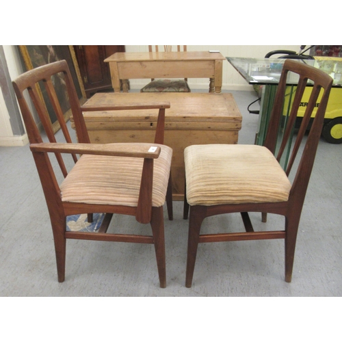 97 - A set of six 1970s teak framed dining chairs, the fabric upholstered seats raised on tapered legs  c... 