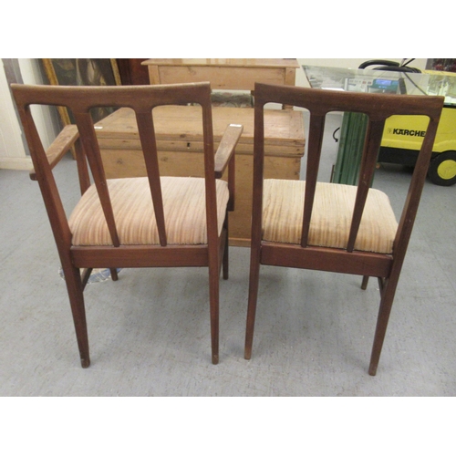 97 - A set of six 1970s teak framed dining chairs, the fabric upholstered seats raised on tapered legs  c... 